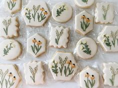 decorated cookies in the shape of flowers and leaves