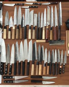 many knives are lined up on a table