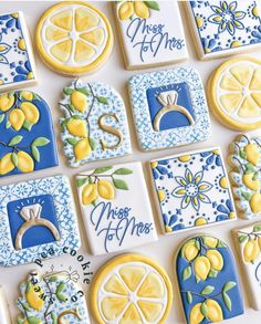 decorated cookies with lemons, blue and white designs are arranged on a counter top