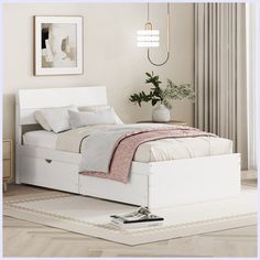 a white bed sitting on top of a wooden floor