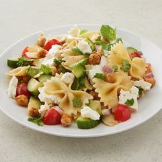 a white plate topped with pasta and vegetables