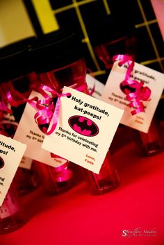 small bottles with pink ribbon tied around them