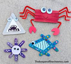 paper cut out animals and fish on the ground with one eye open to see what's inside