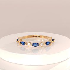 Don't miss out this opportunity to own this Beautiful Gemstone Jewelry ✦✦ Product Info✦✦ =>Gemstone Type - Lab Grown Sapphire => Gemstone Shape - Marquise  =>Side Stone - Cubic Zirconia => Metal Type - 92.5 Sterling Silver- also available in 14k Rose Gold Plated/Gold Plated ✦✦Personalized Order✦✦ We love to take a personalized order, just let me know what style you would like and we will make it just the way you want it, any stone or metal. ✦✦Shipping Time ✦✦ It will take 4-5 Business days to produce and prepare your order for shipping. All of our items are made to order and carefully crafted to meet our philosophy requirements. We require this amount of time to ensure the highest quality, and we appreciate your patience. ✦✦Delivery Timing✦✦ All international shipments are send through sta Marquise Band, Blue Sapphire Wedding Band, Blue Sapphire Wedding Ring, Ring Blue Sapphire, Gold Sapphire Ring, Sapphire Wedding Band, Ring Sapphire, Sapphire Band, Sapphire Wedding