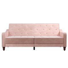 a pink couch sitting on top of a white floor