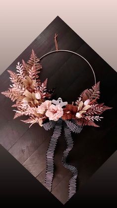 a wreath with flowers and leaves on it