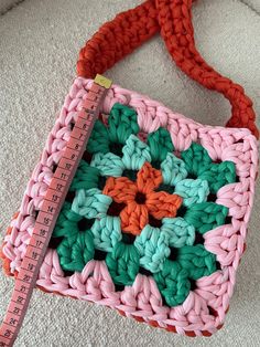 a crocheted purse with a measuring tape