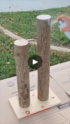 two wooden posts are being sprayed with water