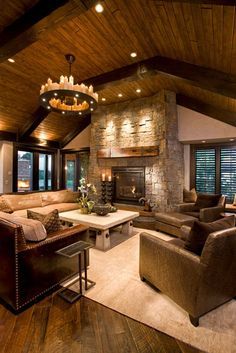 a living room filled with lots of furniture and a fire place in the middle of it