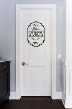 a white door with a sign on it that says, welcome to the laundry room