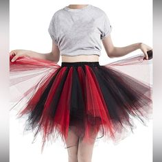 a woman wearing a red and black tulle skirt with white shirt on the back