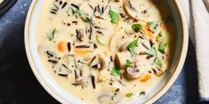 a bowl of soup with mushrooms and carrots