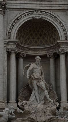 a statue in front of a building with columns