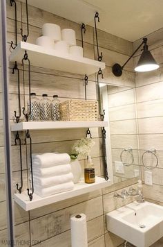 a bathroom with shelving above the sink and toilet paper on the shelf next to it