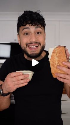 a man holding a sandwich in his right hand and a bowl on the other side