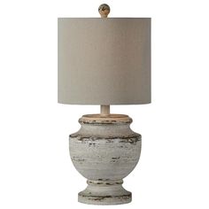 a white table lamp with a beige shade