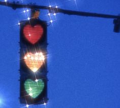 a traffic light that has two hearts on it