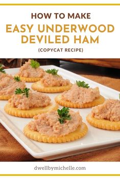 small crackers with tuna and parsley on top are sitting on a white plate