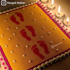 there is a cake with candles on it and two baby feet in the middle,