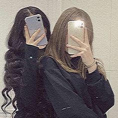 a woman taking a selfie in front of a mirror with her cell phone up to her face