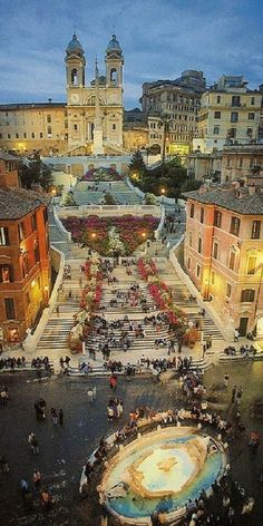 an aerial view of the plaza in front of some buildings and people walking around it