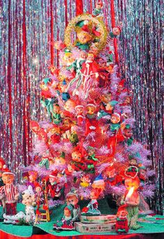 a brightly colored christmas tree with ornaments on it