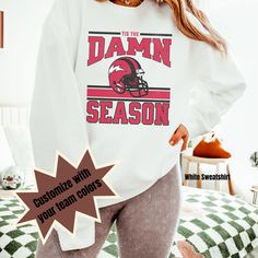 Get ready to show your school spirit in style with our Vintage Style Football Tailgate Comfort Colors Sweatshirt. This oversized crewneck shirt is perfect for game day, whether you're cheering on your high school football team or supporting your favorite sports fan. Made for both men and women, this unisex football tee is a must-have for football moms and sports enthusiasts alike. Upgrade your game-day attire with our comfortable and fashionable football t-shirt. Make a statement and stand out i Crew Neck T-shirt With University Logo For Fall, Varsity T-shirt For College In Fall, College Team Spirit T-shirt For Fall, Crew Neck T-shirt For Game Day In Fall, Varsity Long Sleeve T-shirt With University Logo, Varsity Style Long Sleeve T-shirt With University Logo, School Spirit Graphic Print Sweatshirt With Relaxed Fit, College Style Crew Neck Tops For Sports Events, Collegiate Fall T-shirt With Team Name