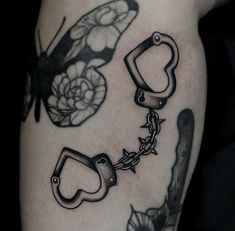 a black and white photo of some tattoos on someone's leg with chains attached to them