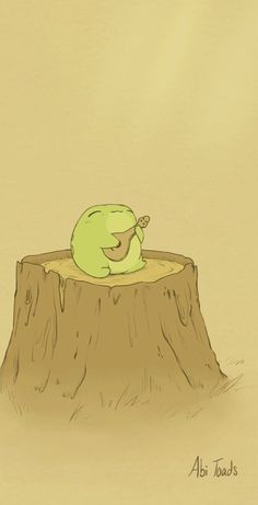 a green bird sitting on top of a tree stump