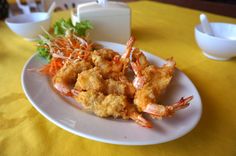 fried shrimp and carrots on a white plate