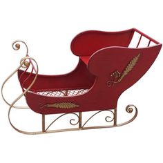 a red wooden sleigh with gold accents