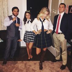 a group of people standing next to each other in front of a door wearing school uniforms