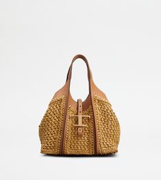 Shopping bag with flowing lines, crafted in raffia with fine crochet detailing and leather inserts. Characterized by the branded metal T Timeless pendant accessory, it comes with two fixed handles, adjustable and removable shoulder strap, internal pouch. Leather Zip Pouch, Tods Bag, Timeless Bags, Timeless Wardrobe Staples, Raffia Bag, Medium Tote, Shopping Tote Bag, Womens Purses, Leather Pouch