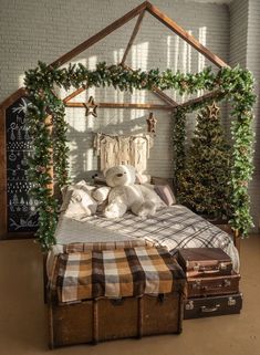 a bedroom with a bed, suitcases and christmas decorations