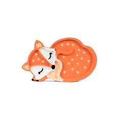 an orange and white toy with a sleeping fox on it's back