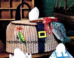 an image of a basket with fish decorations on the lid and two bags in front