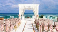 an outdoor wedding set up on the beach