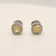 Beautiful yellow natural diamond cushion shape stud earrings. Main Stones: 2 cushion shape natural diamonds first stone: GIA certificate Weight: 0.63 ct Clarity - VS2 Color - Y-Z second stone: GIA certificate Weight: 0.61 ct Clarity - VVS1 Color - W-X Side Stones: 36 Round Shape Natural Diamonds In Weight Of 0.20Ct Clarity - Vs2 Color - F -Shipment made by FedEx/ DHL is fully insured and covered. -The ring shipped in a luxury and elegant box and bug -Certificate Of Authenticity Included By IGL lab Alena Diamonds & Jewelry was created from our passion for custom-made jewelry, and for fulfilling our customer's fantasies. We are Alex and Maayan, we created Alena after years of experience we received by working in the jewelry industry, Starting from diamond gemology in the Israeli diamond exch Elegant Yellow Diamond Earrings With Halo Design, Yellow Halo Design Earrings In Fine Jewelry, Formal Yellow Diamond Earrings With Halo Design, Yellow Halo Design Fine Jewelry Earrings, Yellow Halo Design Earrings Fine Jewelry, Fine Jewelry Yellow Earrings With Halo Design, Classic Yellow Diamond Earrings, Formal Yellow Earrings With Halo Setting, Cushion Cut Diamond Luxury Earrings