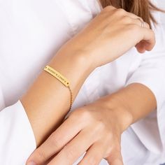 a woman wearing a gold bracelet that says, i love you in cursive writing