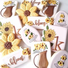 decorated cookies with sunflowers and chocolate frosting on white plates that say welcome