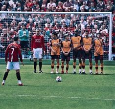 several soccer players are standing on the field