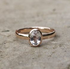 1.5ct oval white sapphire set in a handmade recycled rose gold ring. The sapphire measures 8 x 6mm and  the ring is made in 9ct recycled rose gold. The band is a 3mm oval or court shaped band, gently curved on both sides for a comfort fit. Made to order in your size, orders take 4-6 weeks. The sapphire ring is available on it's own or you can buy an engagement ring set with a matching 3mm wide plain band in rose gold. For other sapphire engagement rings go to: www.etsy.com/shop/karenjohnsondesig Sapphire Rose Gold Ring, Black Diamond Solitaire Ring, Morganite Diamond Ring, Moissanite Wedding Ring Set, Moissanite Ring Set, White Sapphire Engagement Ring, Gold Sapphire Ring, Ring Rosegold, White Sapphire Ring