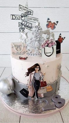 a birthday cake decorated with an image of a woman and shopping bags on the top