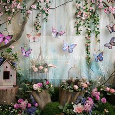 there are many flowers and butterflies hanging on the wall above them, with a birdcage next to it