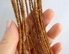 "Long brown necklace, caramel color necklace. The necklace has 9 strands and it's available with silver and gold clasp. Size shown is 30\". More items in caramel: https://www.etsy.com/shop/StephanieMartinCo?ref=simple-shop-header-name&listing_id=160415341&search_query=caramel Please read specifications on SIZES below: ❤ SIZES This item comes in several sizes, kindly choose at checkout. The easiest way to find out which length suits you best is to measure a necklace you already own, from Brown Beaded Necklaces With Tiny Beads, Brown Beaded Necklace With Tiny Round Beads, Brown Multi-strand Beaded Necklace With Gold Beads, Brown Gold Beads Multi-strand Necklace, Bohemian Brown Beads With Gold Details, Brown Multi-strand Wooden Beaded Necklaces, Silver Bar Bracelet, Beaded Boho Necklace, Brown Beaded Necklace