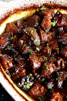 the dish is full of meat and garnished with parsley