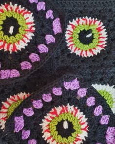 crocheted black and purple doily with multicolored eyeballs