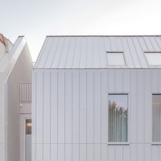 two white houses with windows on each side