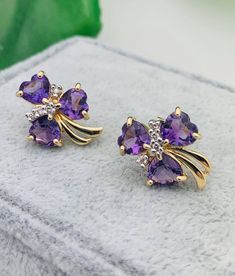 14K Yellow Gold Diamond & Amethyst Clover Leaf Earrings -3/4" Long -5/8" Wide -Six .65 Ct (Each) Heart Amethysts: 5.5mm X 5.5mm -Eight .02 Ct (Each) Round Diamonds: 1mm  -Clarity: SI1 -Color: I Weighs 3.8 grams. Amethyst Jewelry Earrings, Purple Gemstone Accent Earrings For Anniversary, Gold Jewelry Stores, Gold Earrings For Women, Womens Jewelry, Gold Earrings Designs, Amethyst Jewelry, Jewelry Design Necklace, Amethyst Earrings