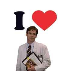 a man in a lab coat and tie holding a book with i heart on it